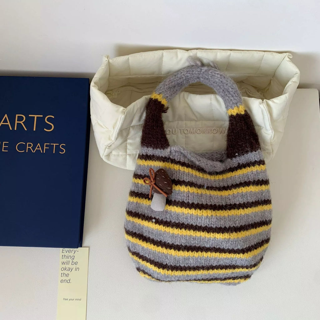 Knitted striped handbag by Shopimist featuring colorful woven fabric, sturdy handle, and stylish design for casual outings.
