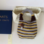 Knitted striped handbag by Shopimist featuring colorful woven fabric, sturdy handle, and stylish design for casual outings.