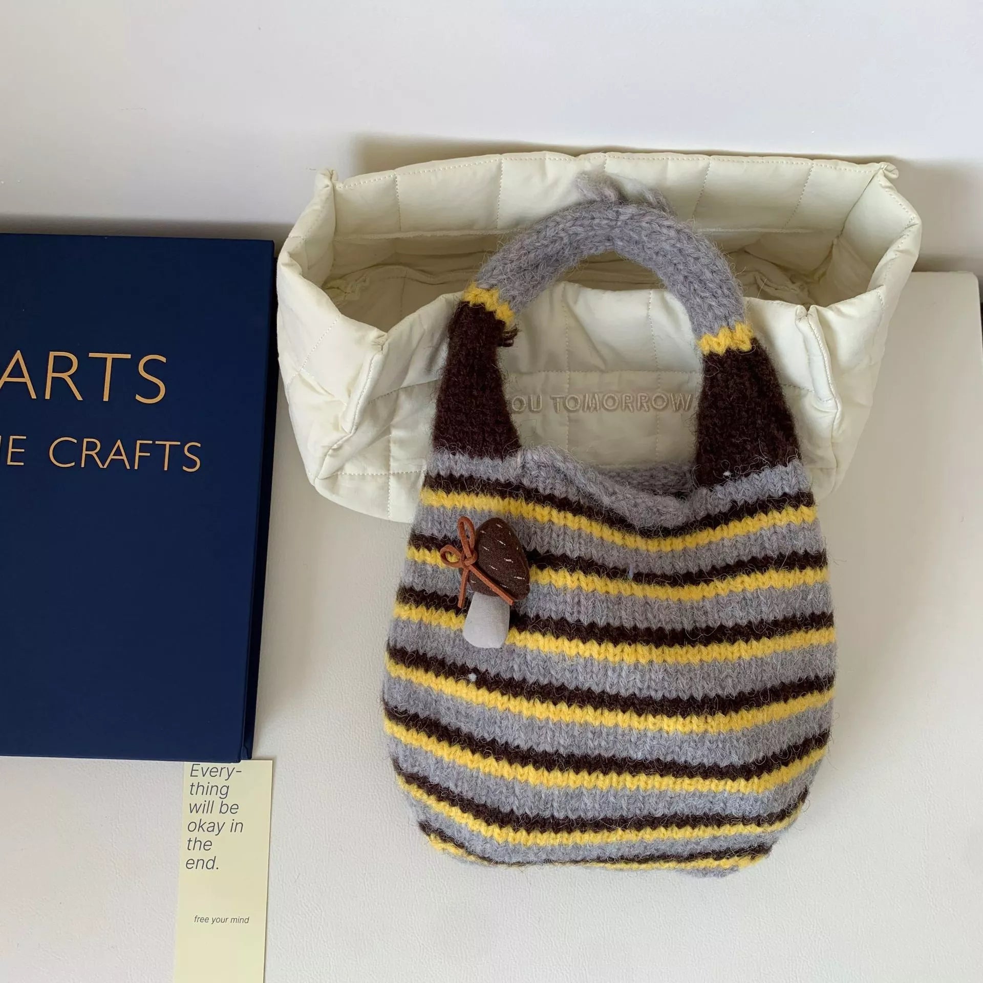 Knitted striped handbag by Shopimist featuring colorful woven fabric, sturdy handle, and stylish design for casual outings.