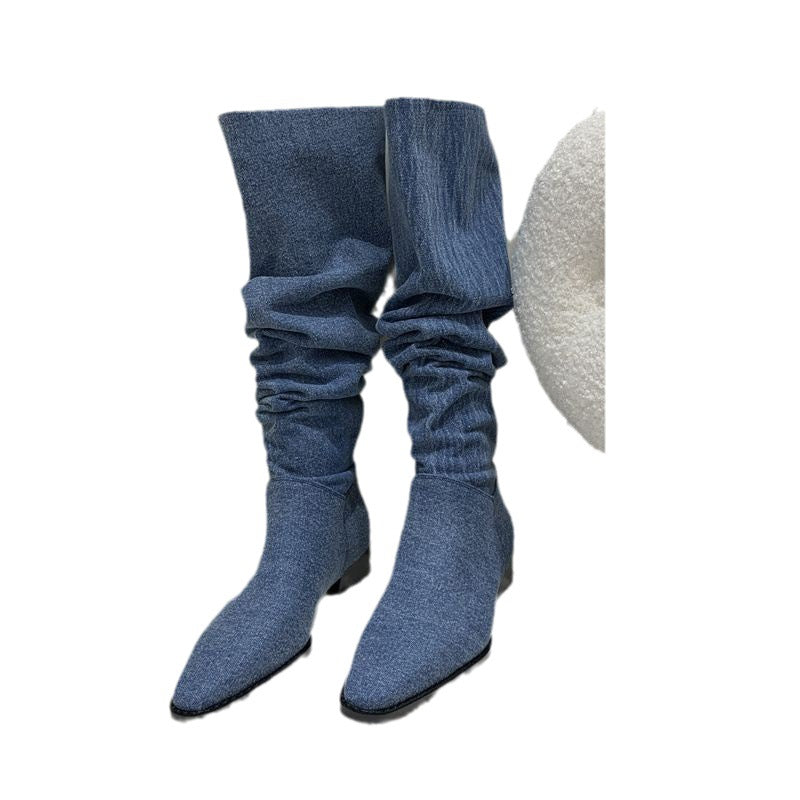 Blue denim knee-high slouchy boots with pointed toes and low heels.