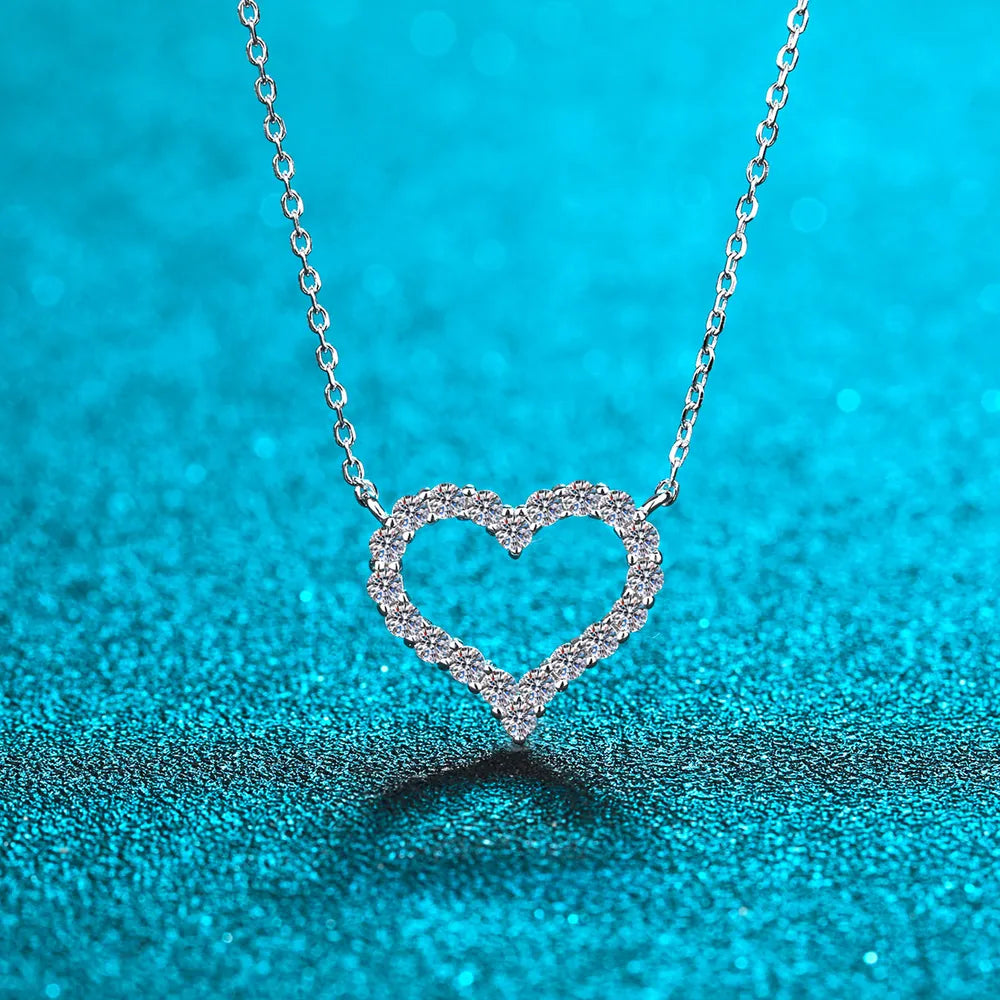 Sterling silver heart-shaped moissanite necklace with a delicate chain, featuring a sparkling gemstone pendant.