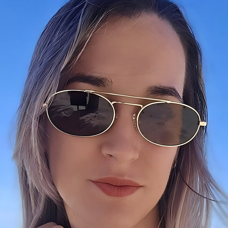 Retro oval dual-beam metal sunglasses with UV protection, featuring sleek metal frames and tinted lenses for stylish eye wear.