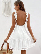 Backless cotton surplice summer mini dress with tassel hem, stylish and lightweight, perfect for warm weather by Trendsi.