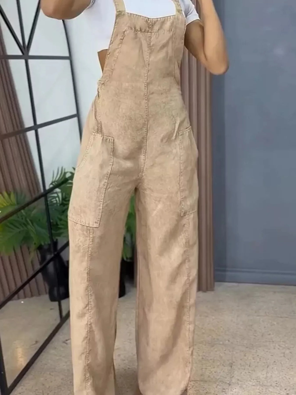 Blue wide-leg denim overalls by Plush Fashion Hub, full-length one-piece jumpsuit with adjustable straps and spacious pockets.