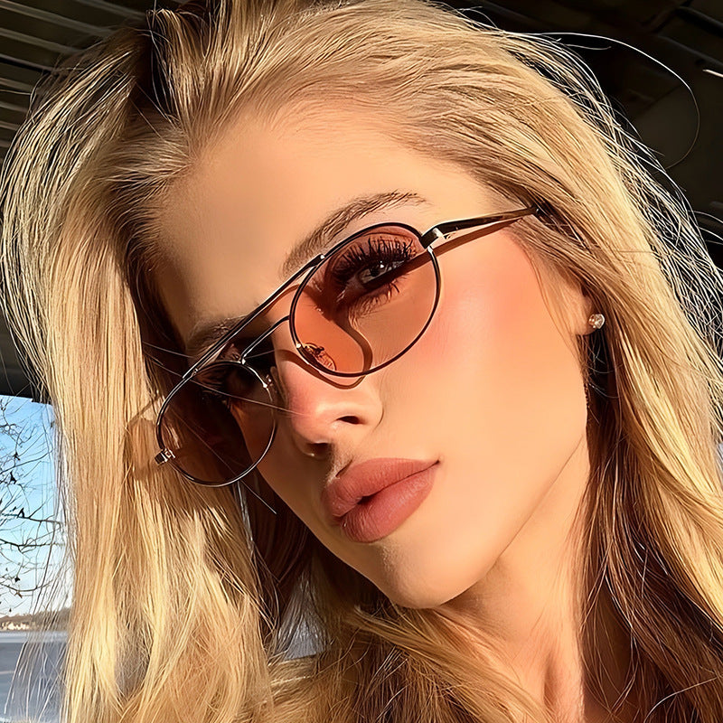 Retro oval metal sunglasses with dual-beam design and UV protection, featuring sleek metal frames and dark tinted lenses.