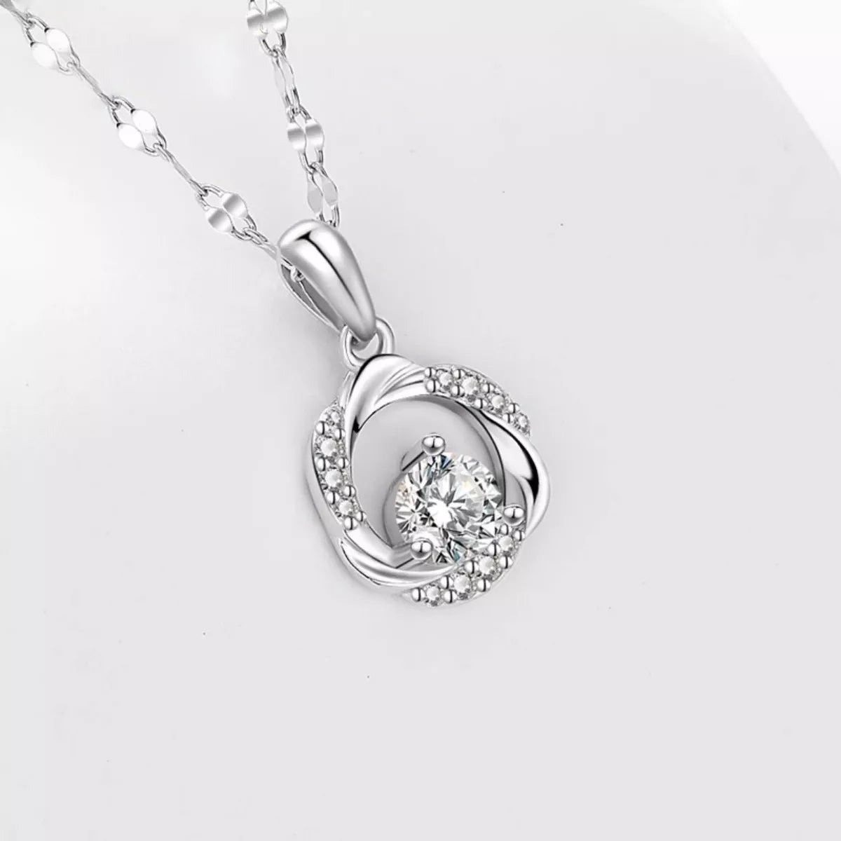 Sterling silver zircon pendant necklace with sparkling gemstone on a delicate chain, showcasing elegant jewelry design.