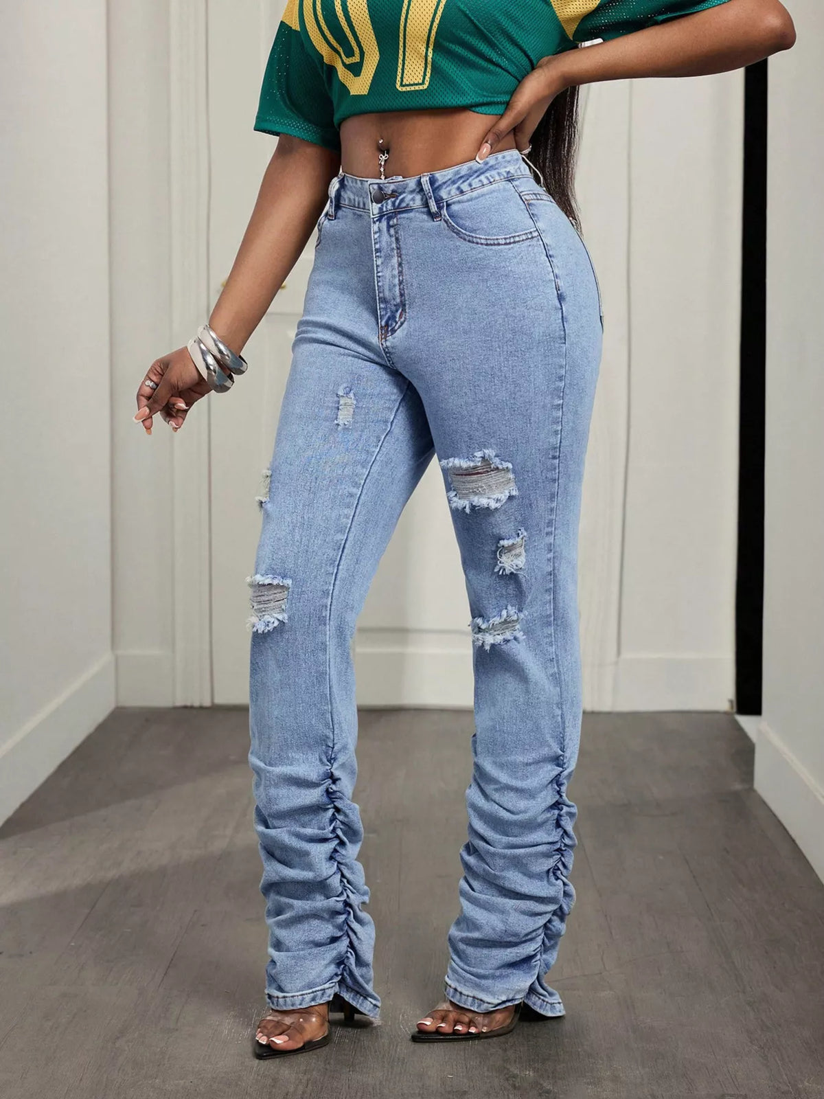 High-waisted distressed stacked hem jeans by Trendsi, showing front view with ripped details and frayed hem.