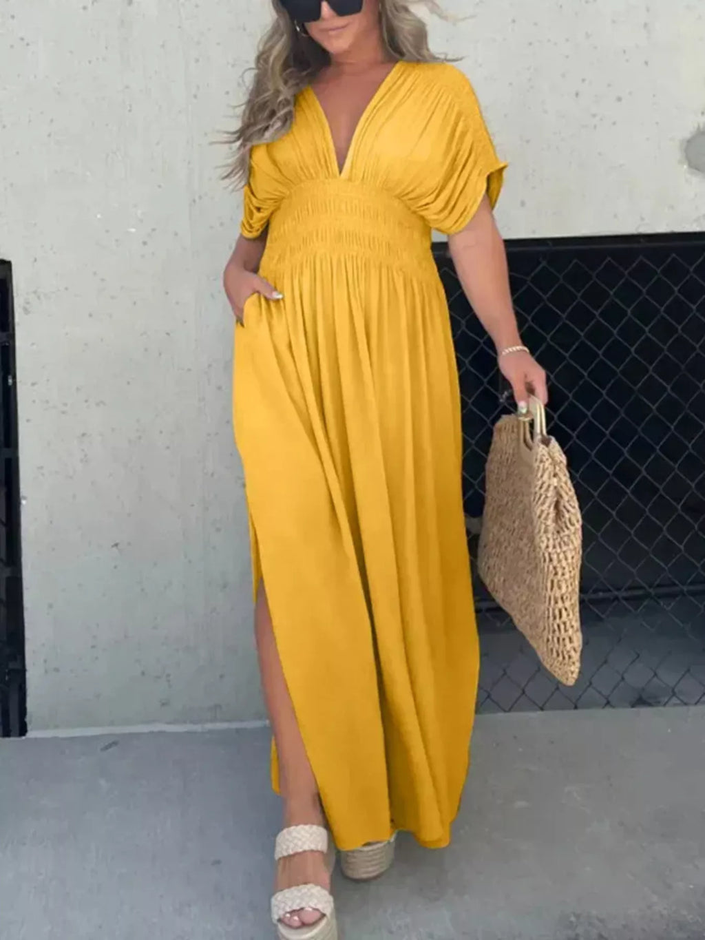 Plus size full length maxi dress with slit, V-neck, and smocked waist by Trendsi, featuring flowing fabric and elegant design.