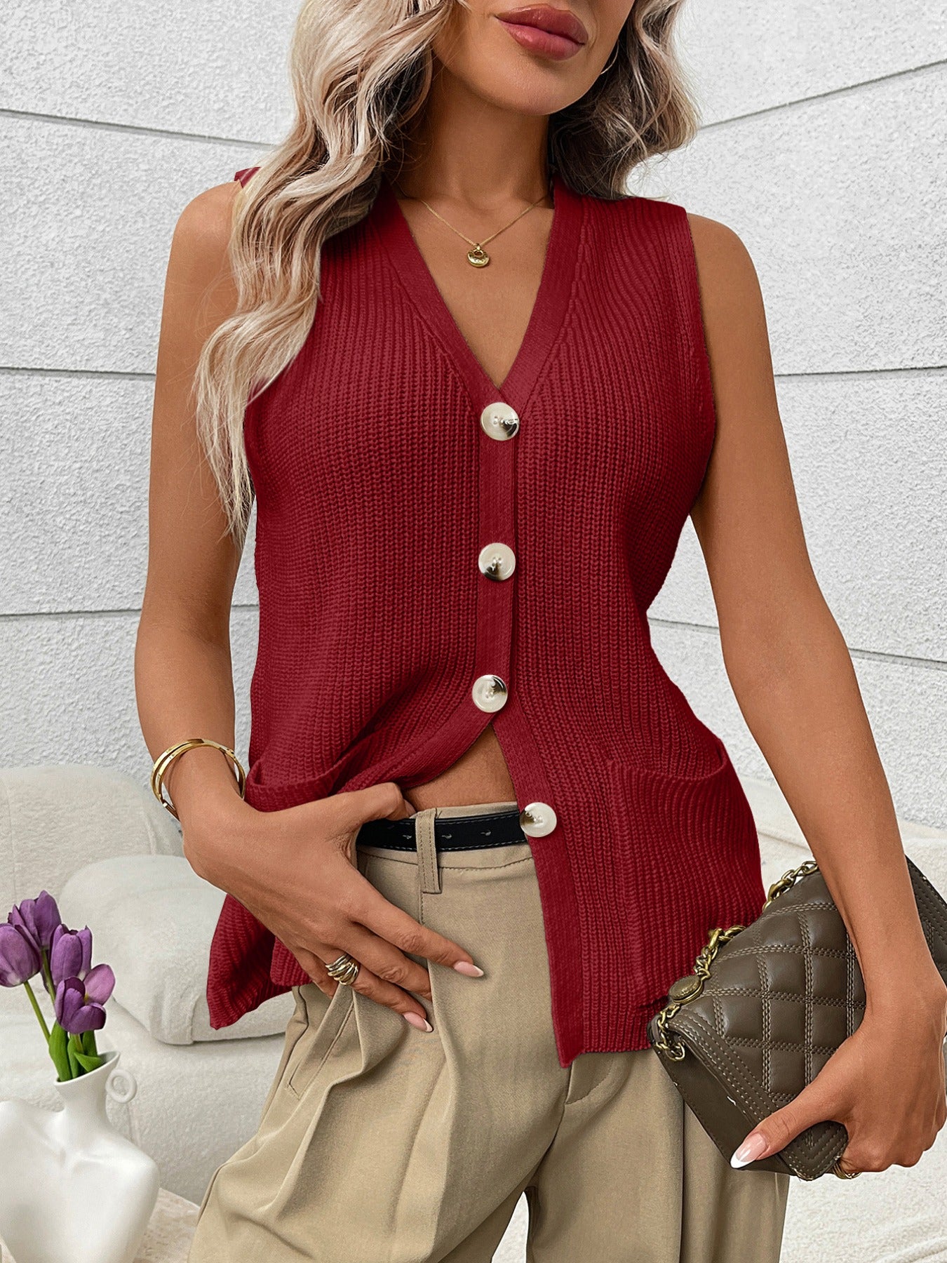 Women's sleeveless knit sweater vest with button-down front and side pockets, stylish Trendsi sweater for layered looks.