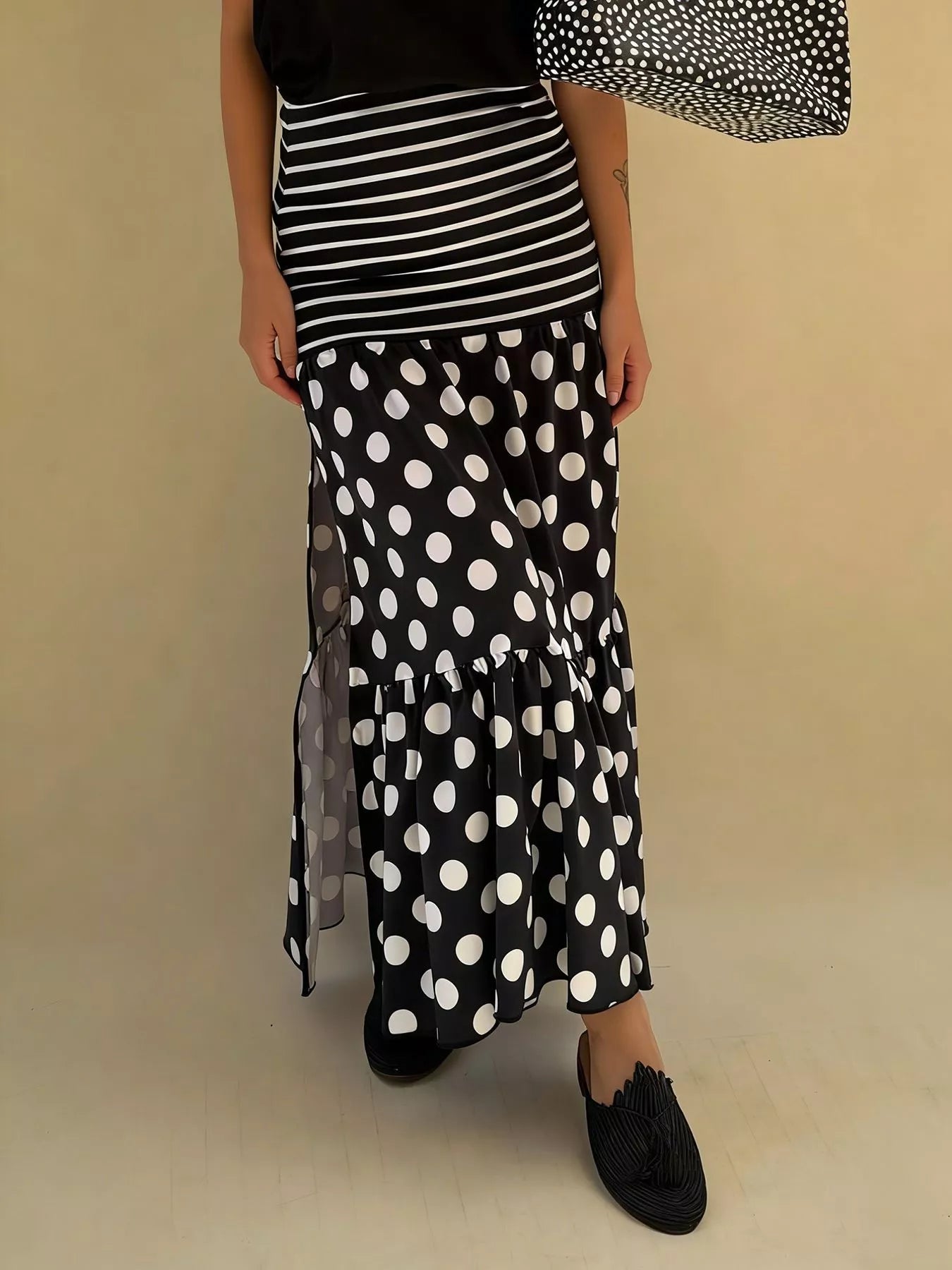 Flowy women's polka dot and striped slit maxi skirt by Trendsi, casual bohemian style with a relaxed, flowing silhouette.