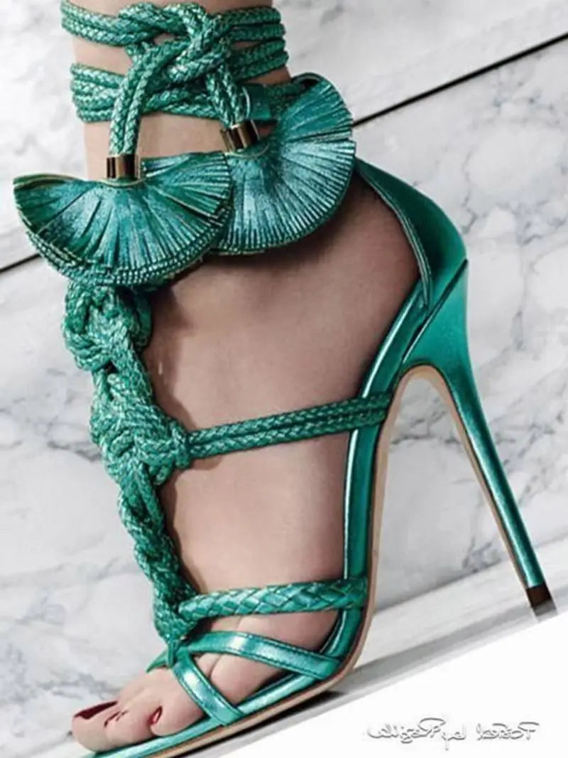 Metallic emerald green braided stiletto sandals featuring ankle lace-ups with decorative pleated tassel accents.
