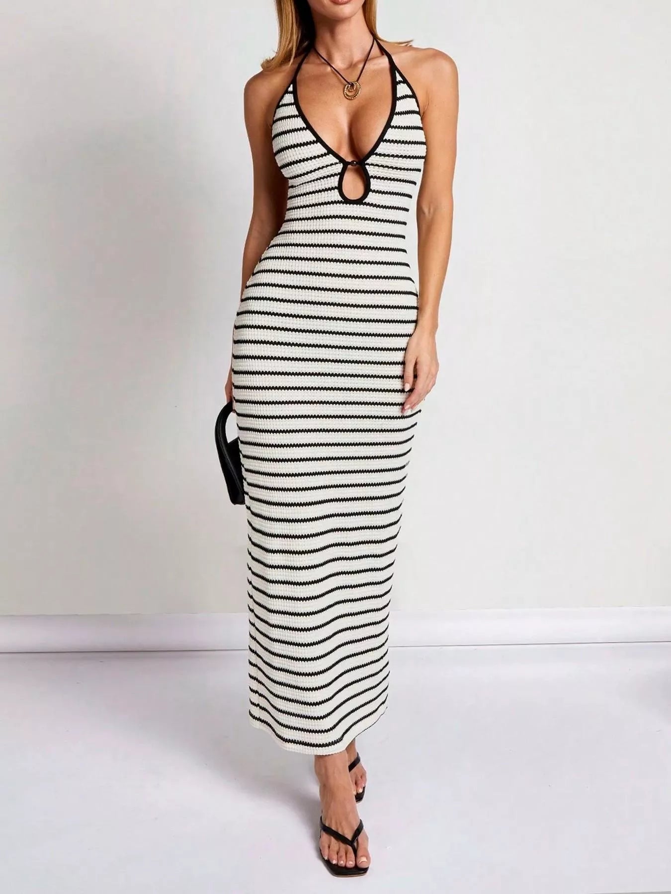 Striped halter neck maxi dress by Plush Fashion Hub with a flowing silhouette and bold horizontal stripe pattern.