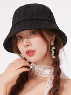 Women's lightweight textured summer bucket hat by Trendsi, showing breathable fabric and casual sun hat style.