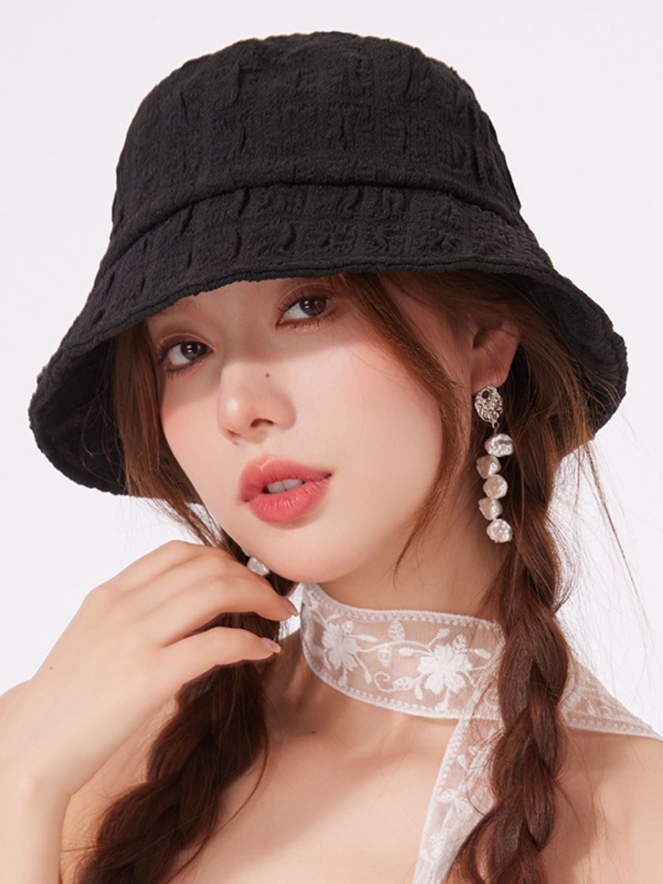 Women's lightweight textured summer bucket hat by Trendsi, showing breathable fabric and casual sun hat style.