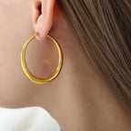 Gold-plated hoop earrings with a polished finish, stylish accessory by Shopimist, perfect for everyday wear and elegant occasions.
