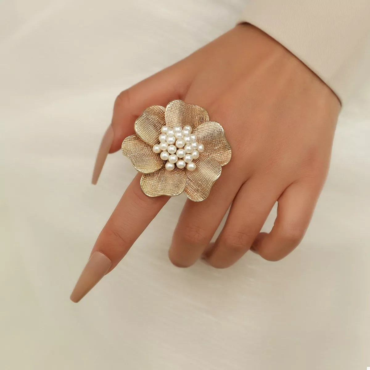 18K gold-plated pearl flower ring with delicate floral design, showcasing elegant jewelry craftsmanship.