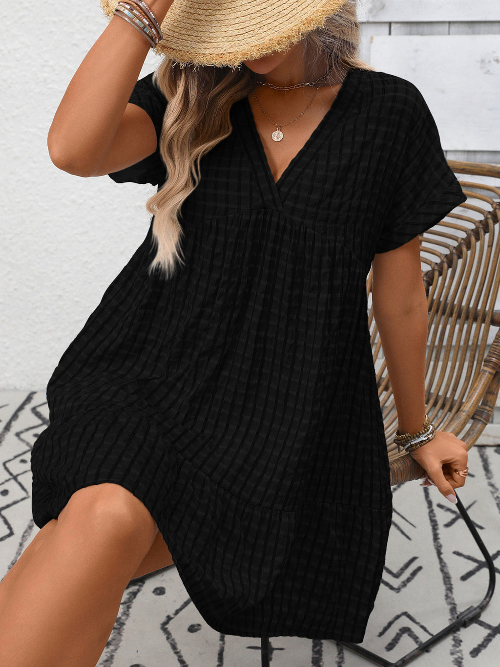 Plush Fashion Hub plaid V-neck mini dress with ruffle hem, lightweight and stylish for seasonal fashion, shown on a model.