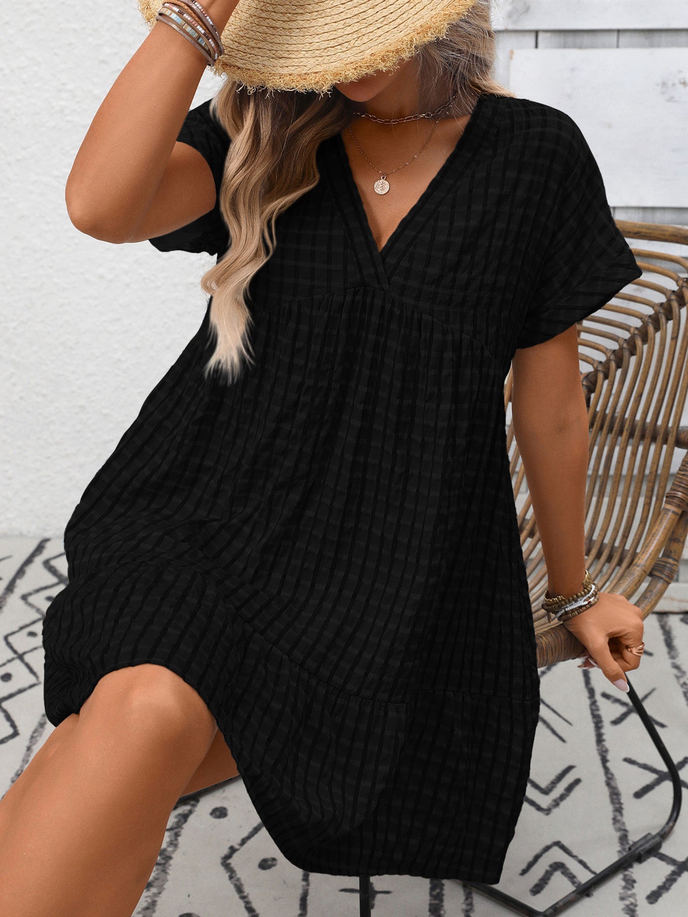 Plush Fashion Hub plaid V-neck mini dress with ruffle hem, lightweight and stylish for seasonal fashion, shown on a model.