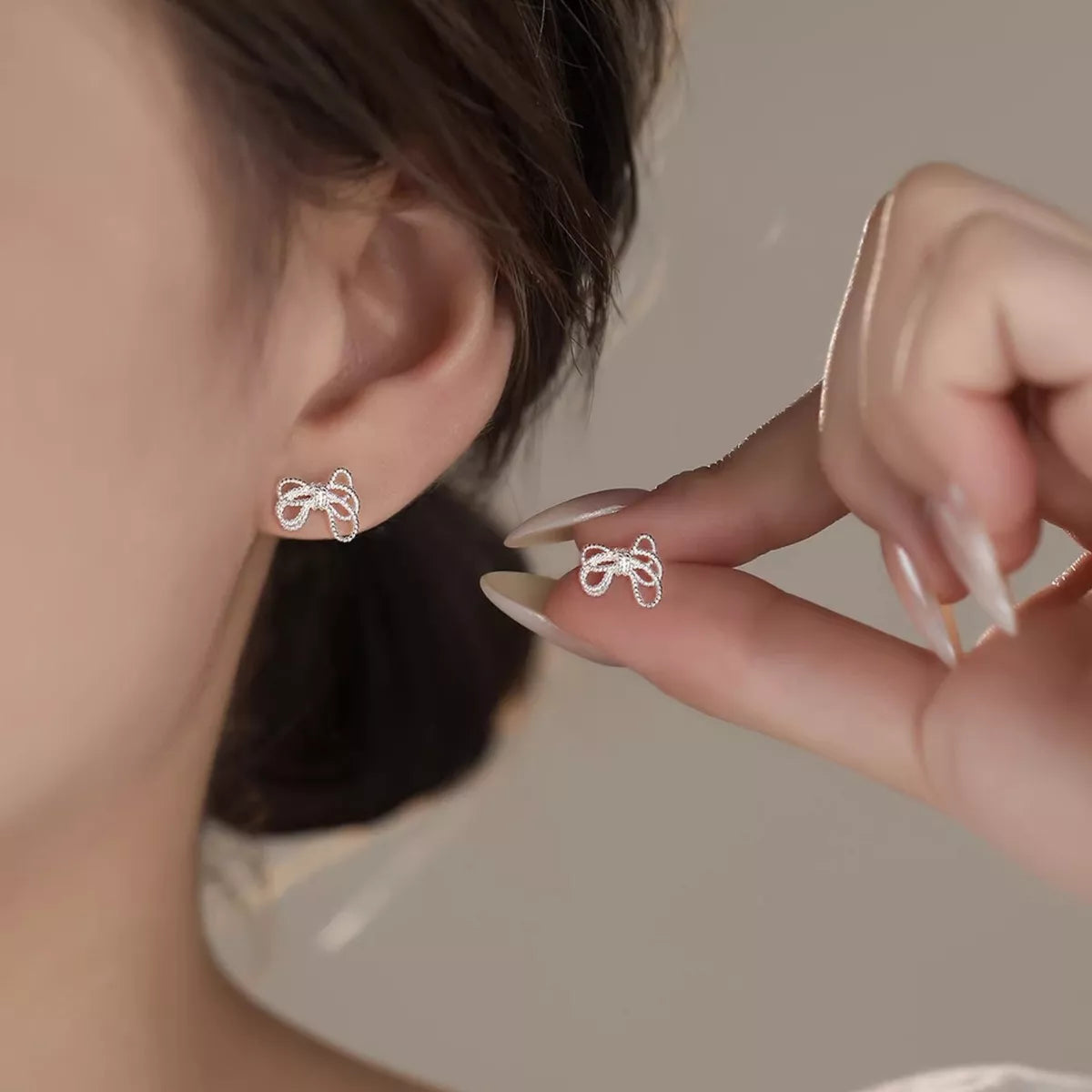 925 Sterling Silver Bow Knot Stud Earrings with polished finish, featuring elegant and delicate jewelry design.