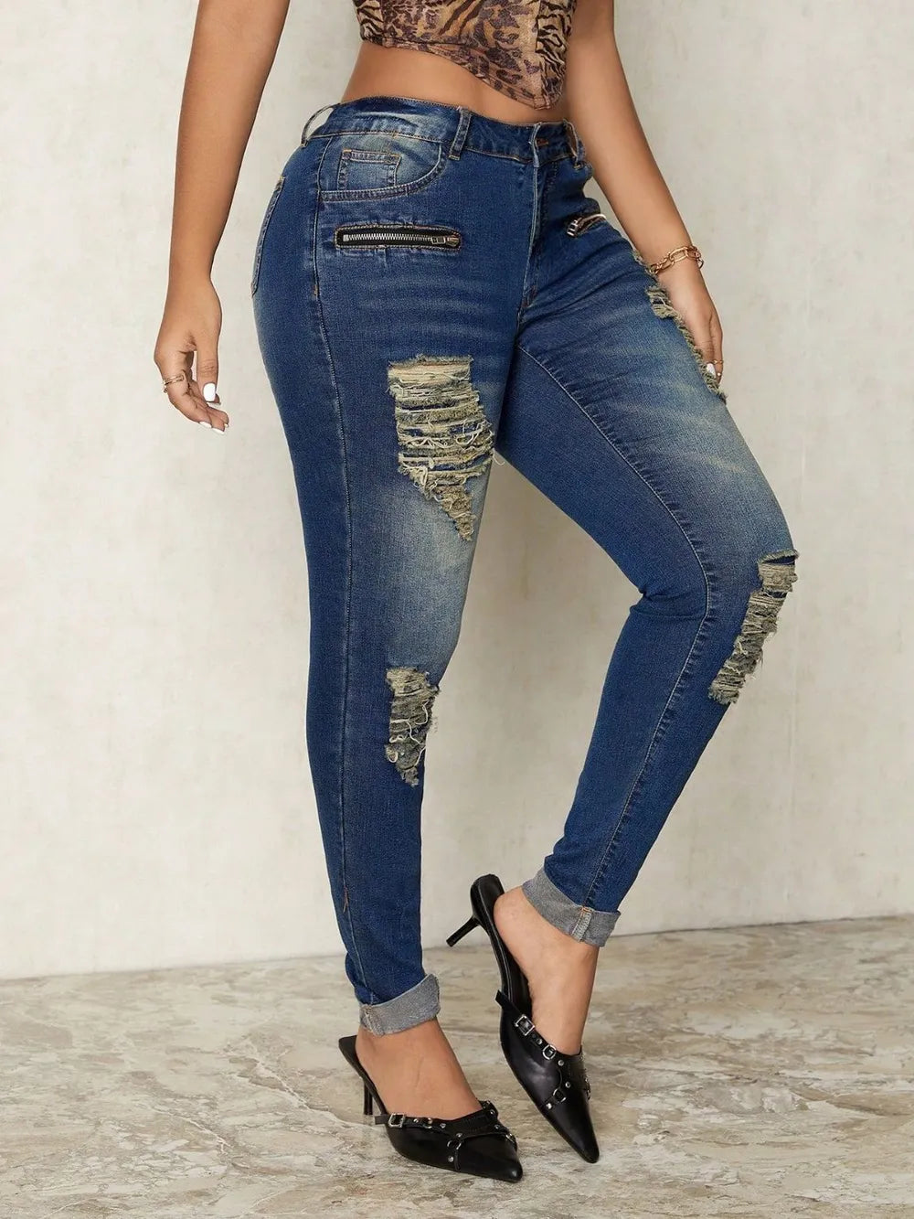 Distressed skinny denim jeans by Plush Fashion Hub featuring ripped details and a fitted silhouette.