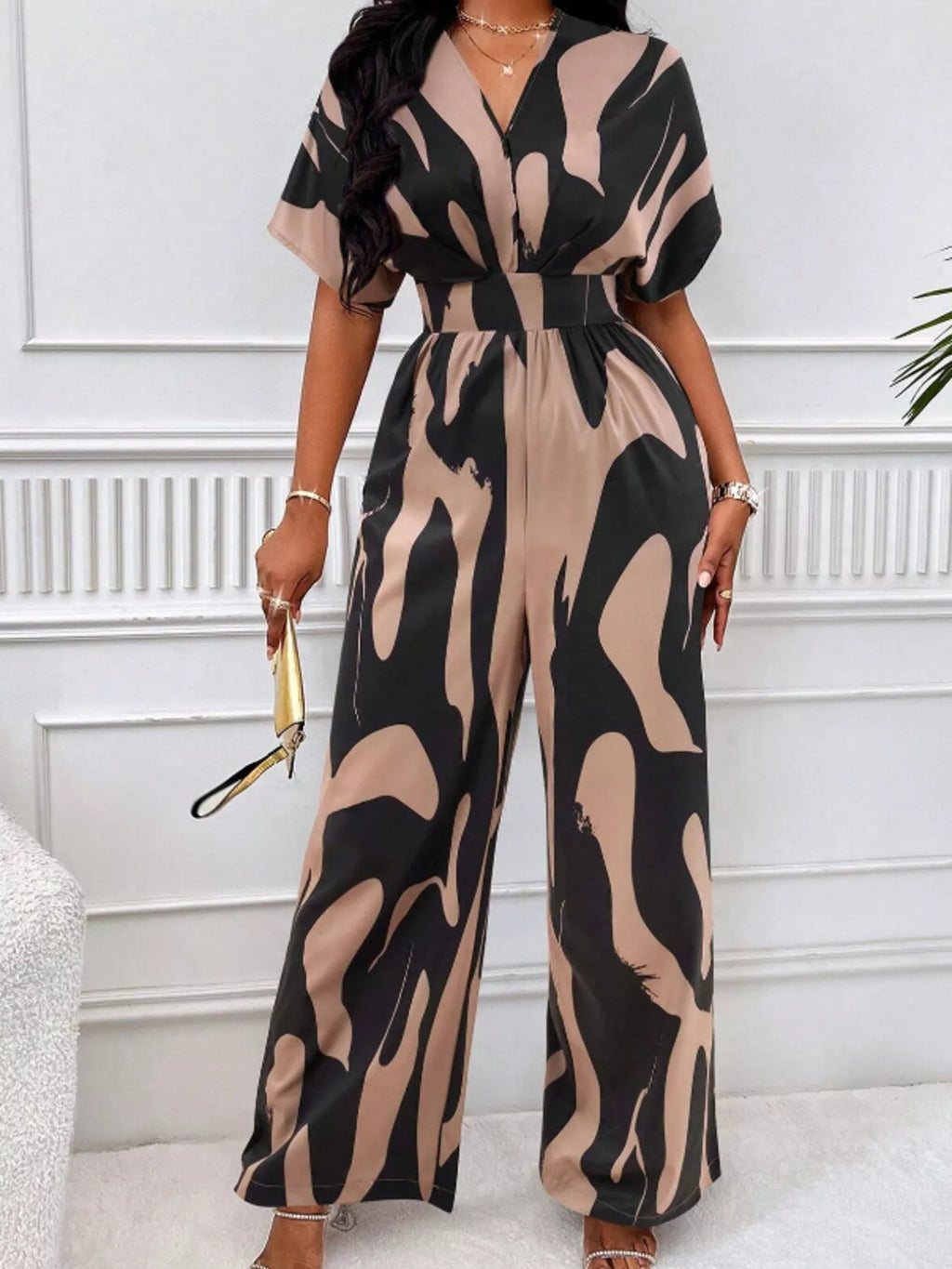 Abstract print wide-leg jumpsuit by Trendsi featuring a relaxed fit and stylish design, perfect for casual or trendy occasions.