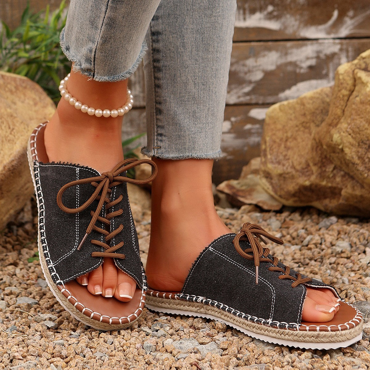 Women's lace-up open toe flat sandals in faux leather with a stylish design, perfect for casual summer wear.