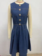 Women's sleeveless denim mini dress with button-front closure, stretchy cotton blend fabric, styled for casual wear.
