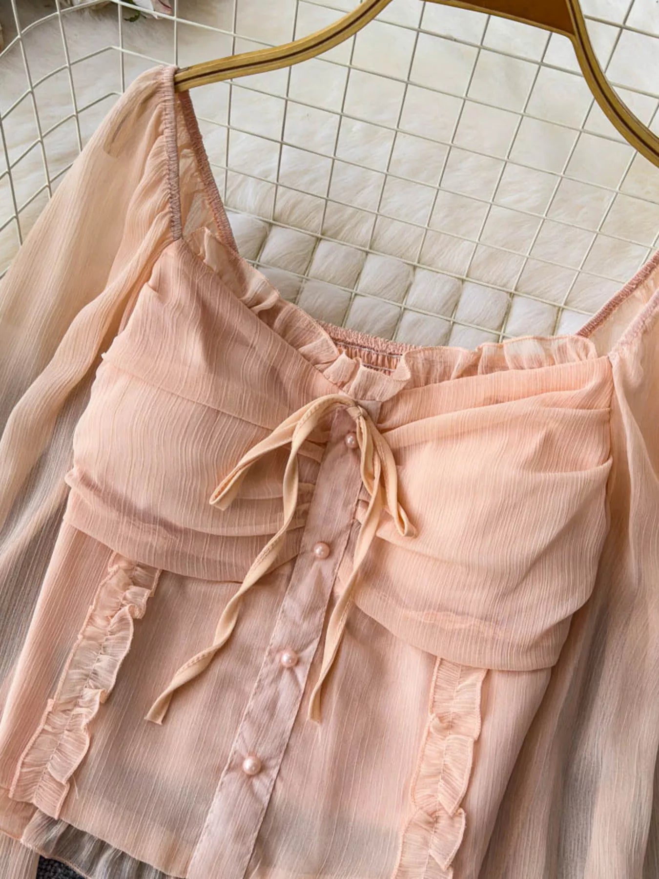 Women's elegant frill flounce sleeve smocked blouse made of lightweight polyester, featuring stylish details and comfortable fit.