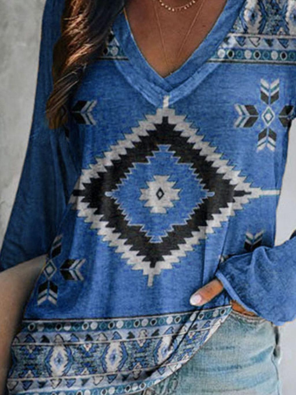 Plus size Geometric Print V-neck long sleeve T-shirt from Trendsi, featuring a casual fit and comfortable fabric.