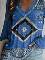Plus size Geometric Print V-neck long sleeve T-shirt from Trendsi, featuring a casual fit and comfortable fabric.
