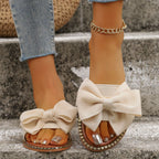 Plush Fashion Hub Bowknot embellished flat sandals with decorative bows and open-toe design, comfortable summer footwear.