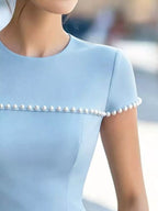 Pearl-embellished peplum T-shirt by Shopimist featuring a fitted silhouette and elegant pearl details on soft fabric.