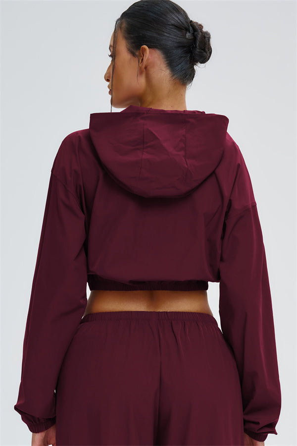 Svelte UV protection crop hoodie by Fitglutes Activewear, lightweight black sportswear with long sleeves and a fitted design.