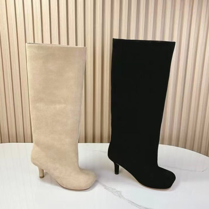 Beige and black suede mid-calf boots with stiletto heels.