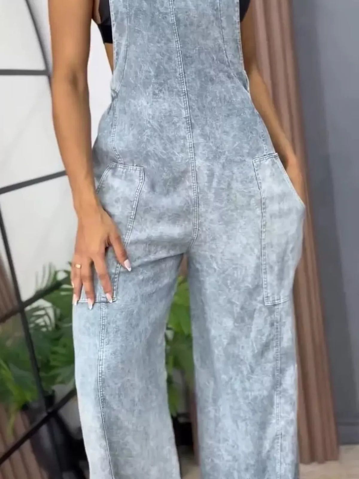 Blue wide-leg denim overalls by Plush Fashion Hub, full-size one-piece jumpsuit with adjustable straps and front pockets.