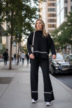 Women’s solid color casual two-piece set by FitiqueFit featuring a loose top and bootcut pants, perfect for relaxed everyday wear.