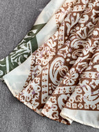Lightweight floral V-neck cami mini dress by Trendsi, perfect for summer casual outings, with a vibrant printed design.