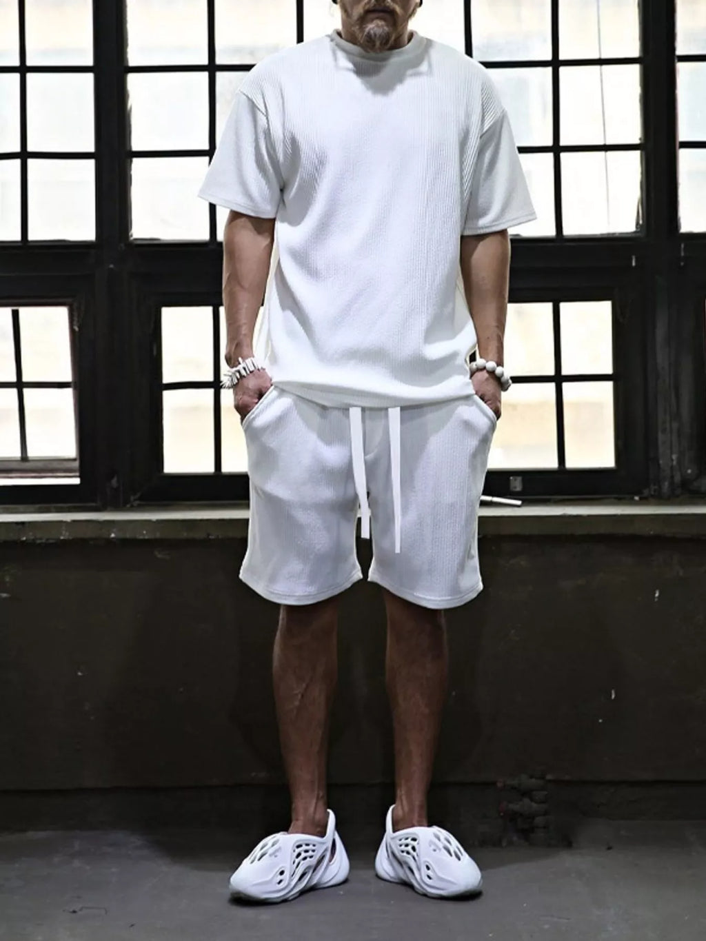 Men's plus size short sleeve top and shorts set by Trendsi, casual matching outfit, front view showing soft fabric and relaxed fit.