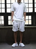 Men's plus size short sleeve top and shorts set by Trendsi, casual matching outfit, front view showing soft fabric and relaxed fit.