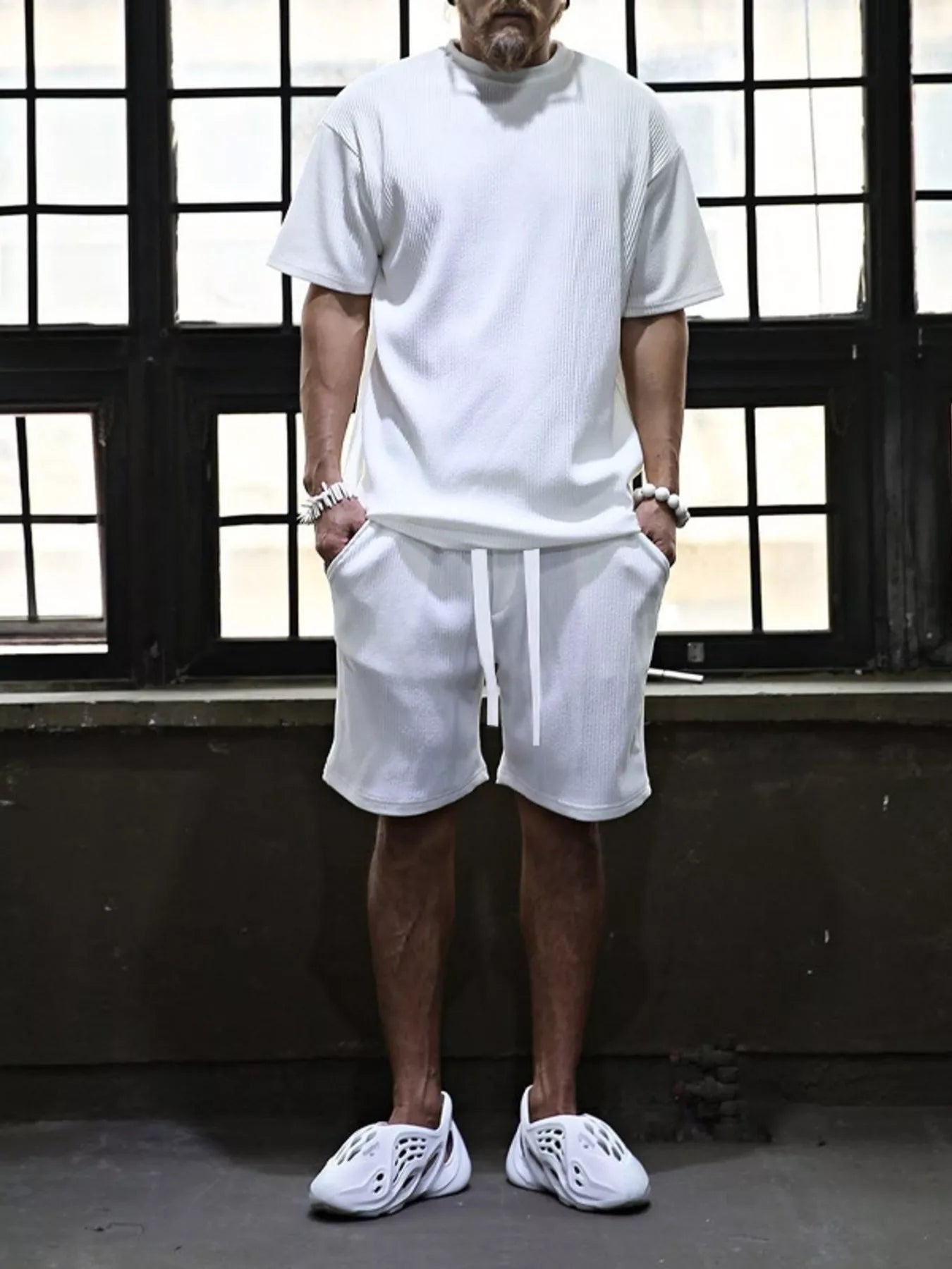 Men's plus size short sleeve top and shorts set by Trendsi, casual matching outfit, front view showing soft fabric and relaxed fit.