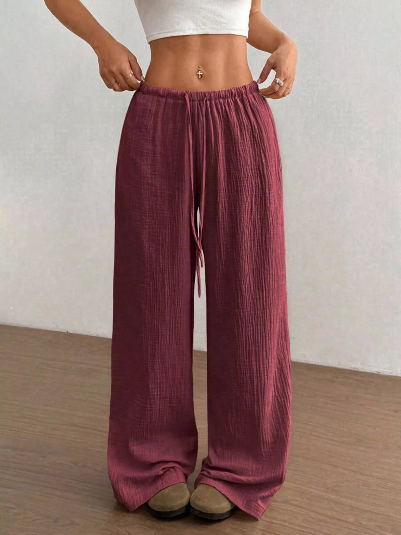 Wide-leg drawstring pants by Trendsi featuring a relaxed fit and casual style, shown in a neutral fabric with a comfortable waistband.