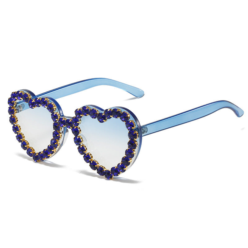 Peach heart-shaped rhinestone sunglasses with Y2K style, trendy eyewear from Plush Fashion Hub featuring sparkling rhinestones.