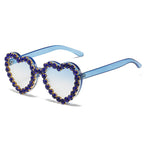 Peach heart-shaped rhinestone sunglasses with Y2K style, trendy eyewear from Plush Fashion Hub featuring sparkling rhinestones.