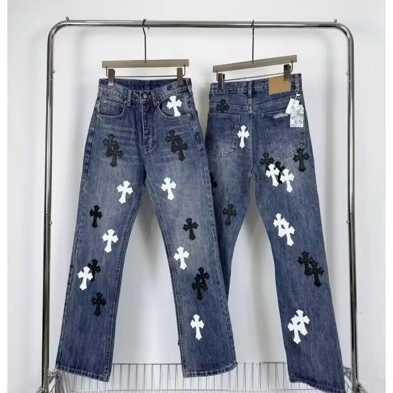 Blue denim jeans with black and white cross patches, front and back views on a clothing rack.