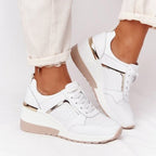 White lace-up platform sneakers with perforated mesh details, metallic gold accents, and a beige rubber sole.
