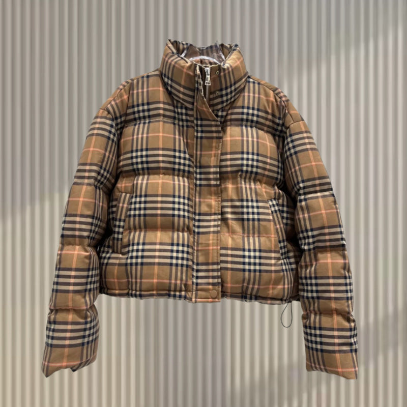 Tan, black, and peach plaid short puffer jacket with a high collar, zipper, and snap placket.