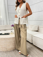 Women's sleeveless knit sweater vest with buttons and side pockets, stylish Trendsi sweater for layered fall outfits.
