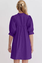 Women's cotton babydoll mini dress with puff sleeves, notched neckline, and pockets by Trendsi, shown in a stylish, casual fit.