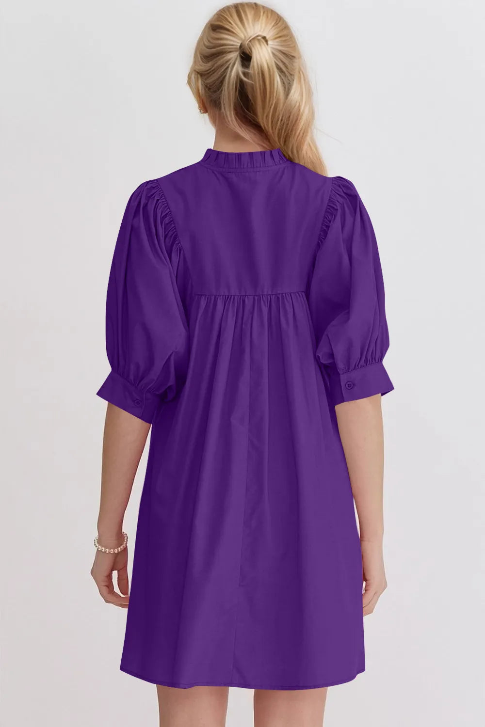 Women's cotton babydoll mini dress with puff sleeves, notched neckline, and pockets by Trendsi, shown in a stylish, casual fit.