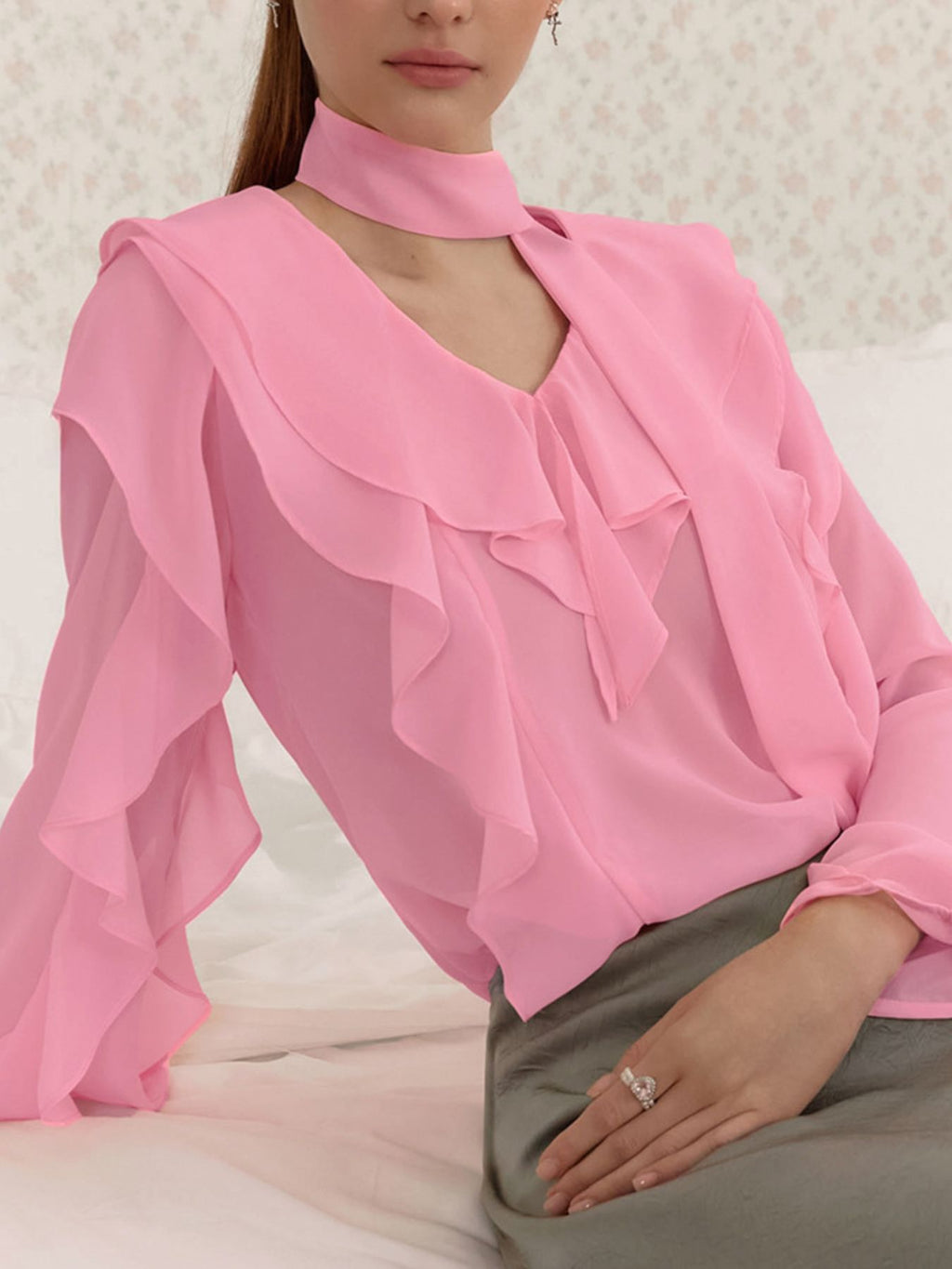 Elegant chiffon blouse with ruffle trim and tie neck detail, featuring a flowy, lightweight fabric and feminine design.